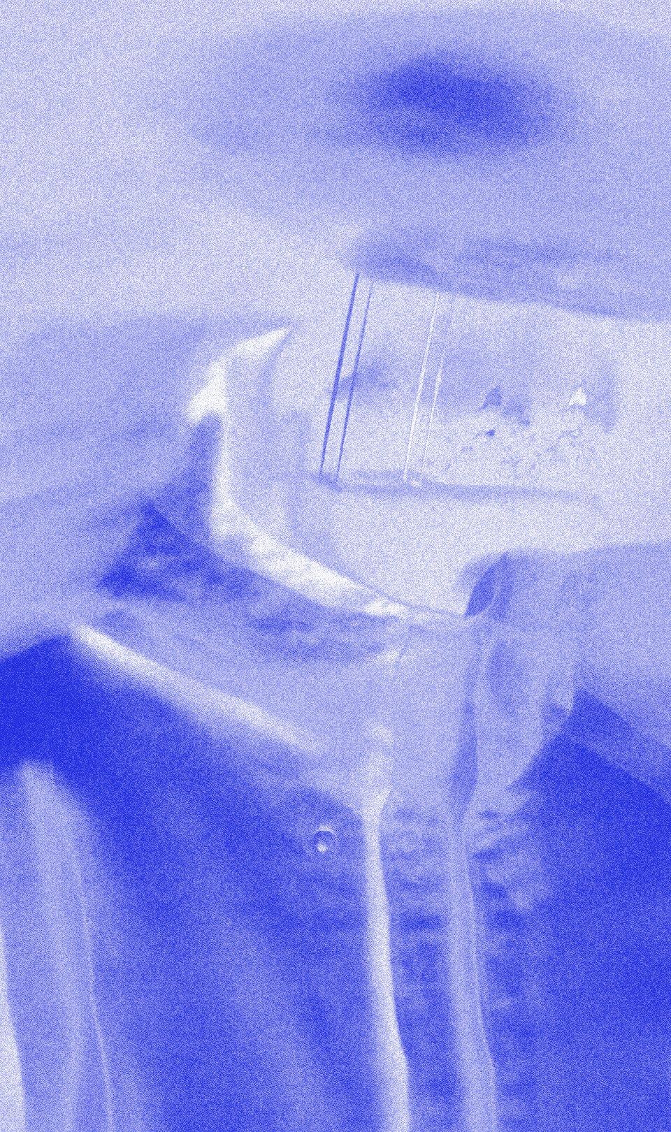 A figure behind frosted glass, toned cobalt